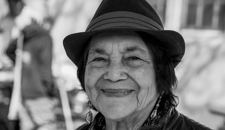 Black and white smile picture of Dolores Huerta, American labor leader and civil rights activist, showing her inspiring and confident personality.