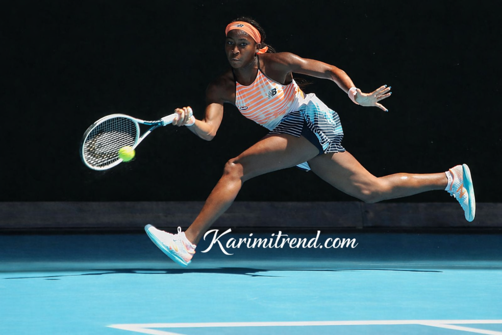 Coco Gauff playing tennis during a match, hitting a forehand shot with strong athletic movement